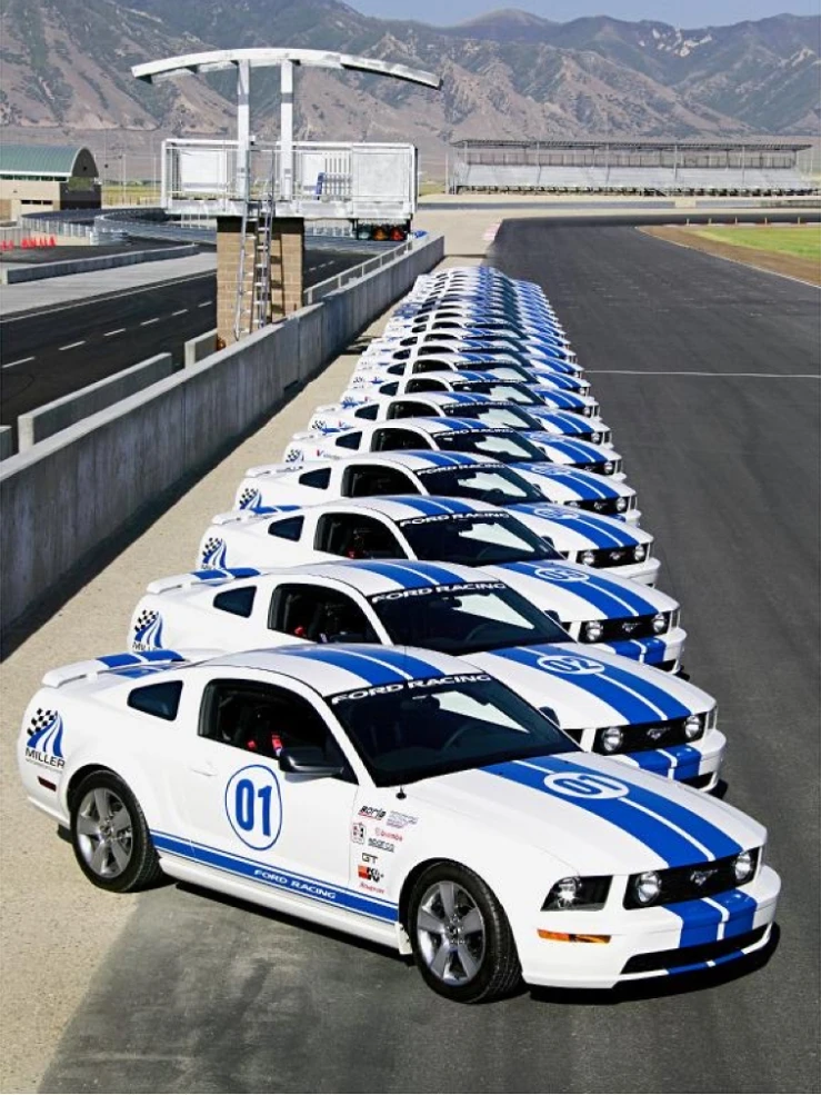 Row of Ford Performance Racing School Mustangs lined up on pit lane
