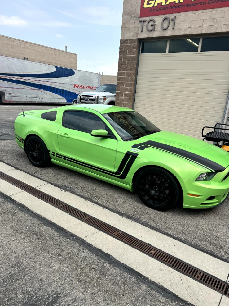 Green Ford Mustang with black hood and side stripes installed by Falcon Graphics