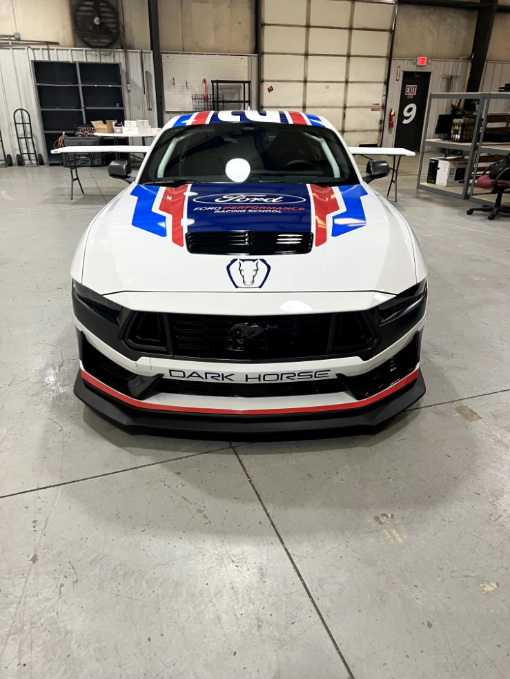 Front of a Mustang Dark Horse with red, white, and blue hood graphics